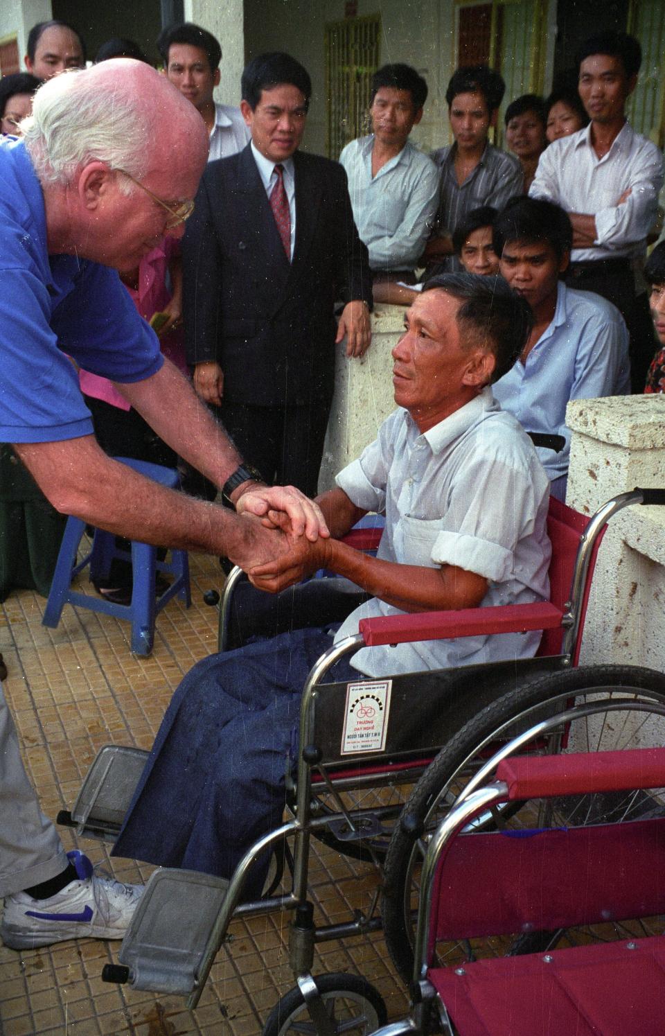 Patrick Leahy,  in 1996, shakes hands with a Vietnamese man injured by a landmine  who received  a wheelchair at a clinic in Vietnam funded through the Leahy War Victims Fund.
Sen. Patrick Leahy, D-Vt., in 1996,  shakes hands with a Vietnamese man injured by a landmine gets who received his first wheelchair at a clinic in Vietnam funded through the Leahy War Victims Fund.