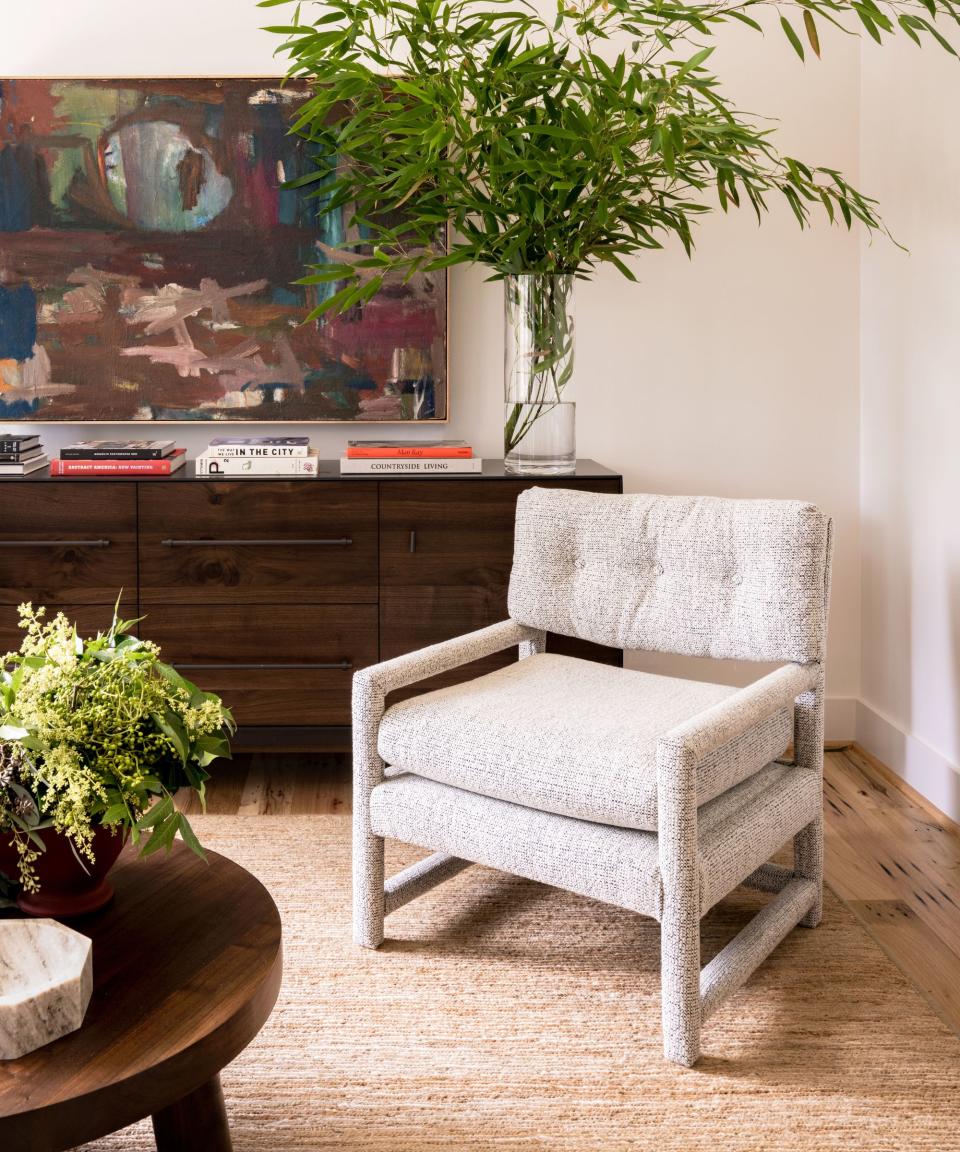 Grey chair, dark wooden cabinet and wooden table