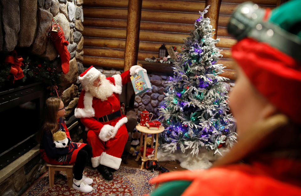 Santa and his Elf helpers are seen in a grotto during a Christmas photo-call at Hamleys toy store, in London, Britain, September 29, 2022.  REUTERS/Peter Nicholls