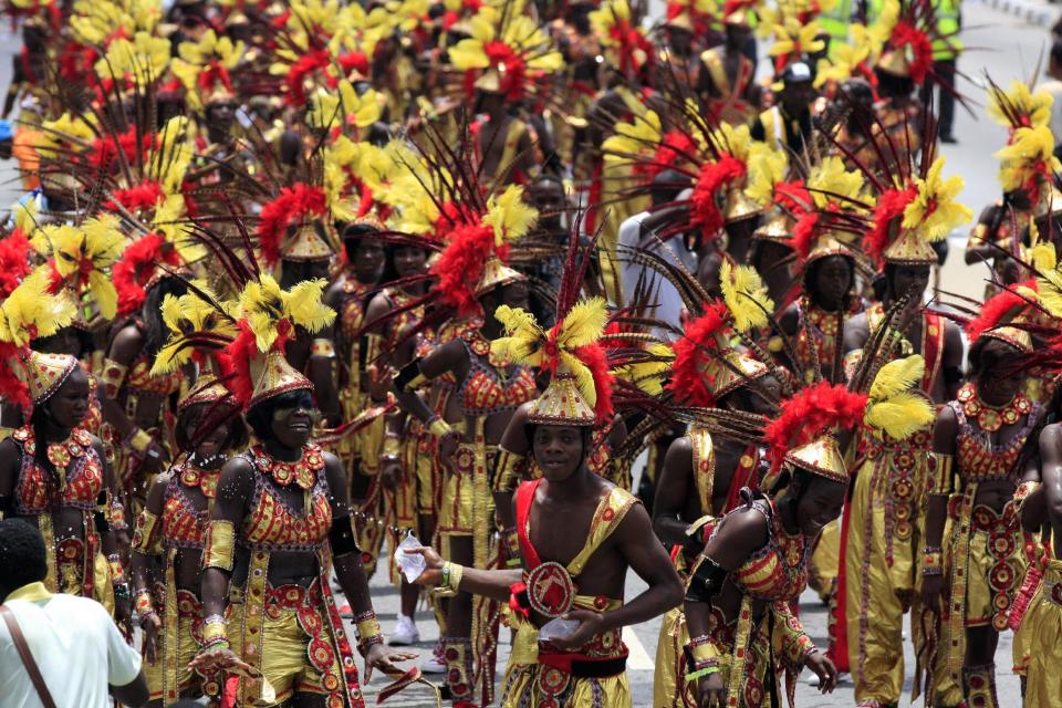 Performers walk through the street during Lagos Carnival in Lagos, Nigeria, on Monday, April 1, 2013. Performers filled the streets of Lagos' islands Monday as part of the Lagos Carnival, a major festival in Nigeria's largest city during Easter weekend. (AP Photo/Jon Gambrell)