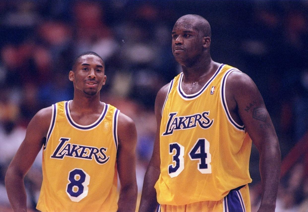 Los Angeles Lakers center Shaquille O'Neal (right) and guard Kobe Bryant confer during a game against the Minnesota Timberwolves at the Great Western Forum in Inglewood, California on Dec 8, 1996: The Lakers won the game, 110-86.