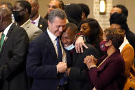 Attorney Tony Romanucci, center left, hugs Donald Williams, a key witness in the trial of former Minneapolis police Officer Derek Chauvin, during a news conference after the guilty verdict was read, Tuesday, April 20, 2021, in Minneapolis. (AP Photo/Julio Cortez)
