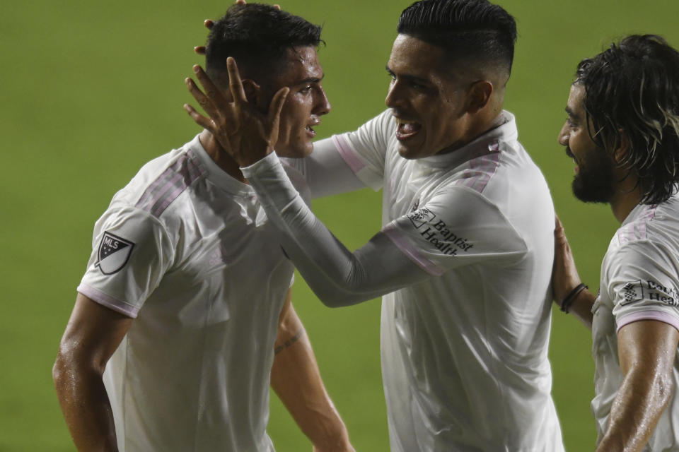 Inter Miami forward Julian Carranza, left, is congratulated on his second goal against Orlando City by teammates Victor Ulloa, center, and Rodolfo Pizarro during the first half of an MLS soccer match Saturday, Aug, 22, 2020, in Fort Lauderdale, Fla. (AP Photo/Jim Rassol)