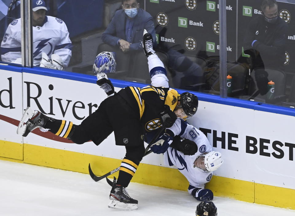 Boston Bruins left wing Nick Ritchie (21) takes out Tampa Bay Lightning left wing Ondrej Palat (18) during the first period of an NHL hockey playoff game Wednesday, Aug. 5, 2020 in Toronto. (Nathan Denette/The Canadian Press via AP)