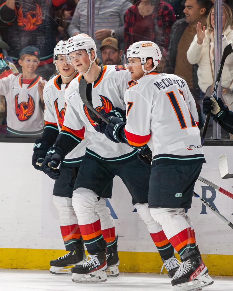 Ville Ottavainen (36) celebrates with his teammates after netting his first professional hockey goal during the game at Acrisure Arena in Thousand Palms, CA, on November 11, 2023.