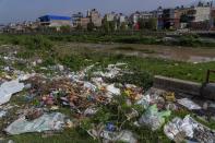 Garbage sits on the banks of the Bagmati River in Kathmandu, Nepal, Tuesday, May 24, 2022. Mala Kharel, an executive member of a governmental committee set up to help clean up the river, said that over the years the campaign has succeeded in collecting about 80% of garbage along the riverbank. But the pickup efforts admittedly fall short, in part since frequent disruptions to trash collection services encourage more dumping than they can keep up with. (AP Photo/Niranjan Shrestha)