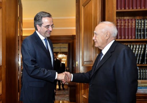 New Democracy leader Antonis Samaras (left) meets Greek President Carolos Papoulias in Athens. Samaras was been sworn in as the prime minister of new Greek coalition, as he took up the challenge of trying to revise the terms an unpopular EU-IMF bailout deal