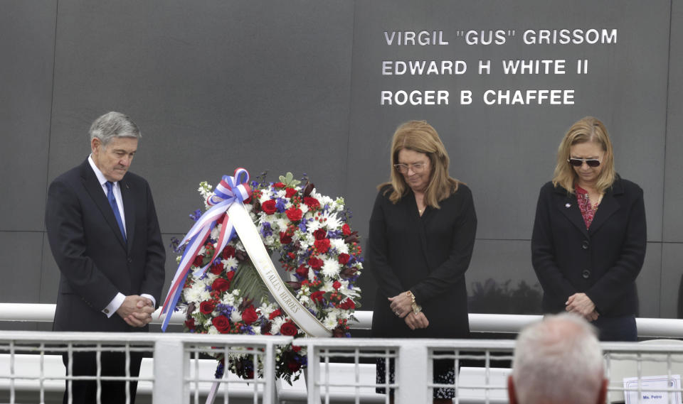 From left, Bob Cabana, Associate Administrator of NASA; Sheryl Chaffee, daughter of Apollo 1 astronaut Roger Chaffee, and Janet Petro, NASA KSC director, bow their heads in prayer during NASA's Day of Remembrance ceremony, hosted by the Astronauts Memorial Foundation at Kennedy Space Center Visitor Complex, Thursday, Jan. 26, 2023. NASA is marking the 20th anniversary of the space shuttle Columbia tragedy with somber ceremonies during its annual tribute to fallen astronauts. (Joe Burbank/Orlando Sentinel via AP)