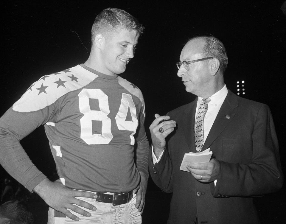 FILE - In this Aug. 10, 1960, file photo, Jim Houston (84) of Ohio State is interviewed by Paul Hornung, sports editor of the Columbus Dispatch, at Soldier Field in Chicago. Houston's widow would keep notes on her husband's deteriorating condition in a three-ring binder so she would be prepared for the day when he needed full-time care. (AP Photo/Edward Kitch, File)