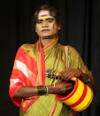 <p>An Indian transgender Bhagyamma Jogathi holds a traditional musical instrument as she poses for a portrait after performing at the International Trans Art Festival in Bangalore, India, July 29, 2016. The community of transgender artists known as Jogathis from southern Indian state of Karnataka perform at festivals and various other occasions to earn their livelihood. (Photo: Aijaz Rahi/AP)</p>