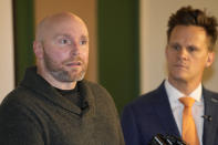 Scott Verti responds to questions during a news conference ast the Denver Press Club on Thursday, Jan. 19, 2023, in Denver. Verti, who says he was repeatedly sexually abused as a teenager by a Catholic priest while serving as an altar boy in a parish in Fort Collins, Colo., is suing that defrocked priest and the Archdicese of Denver. One of Verti's lawyers, Kurt Zaner, back, looks on. (AP Photo/David Zalubowski)