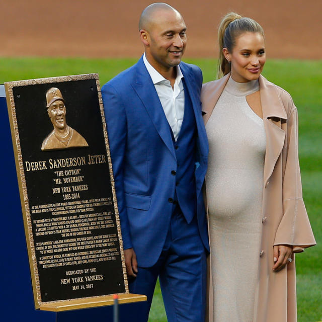 Derek Jeter stands on the field with Hannah Jeter and other