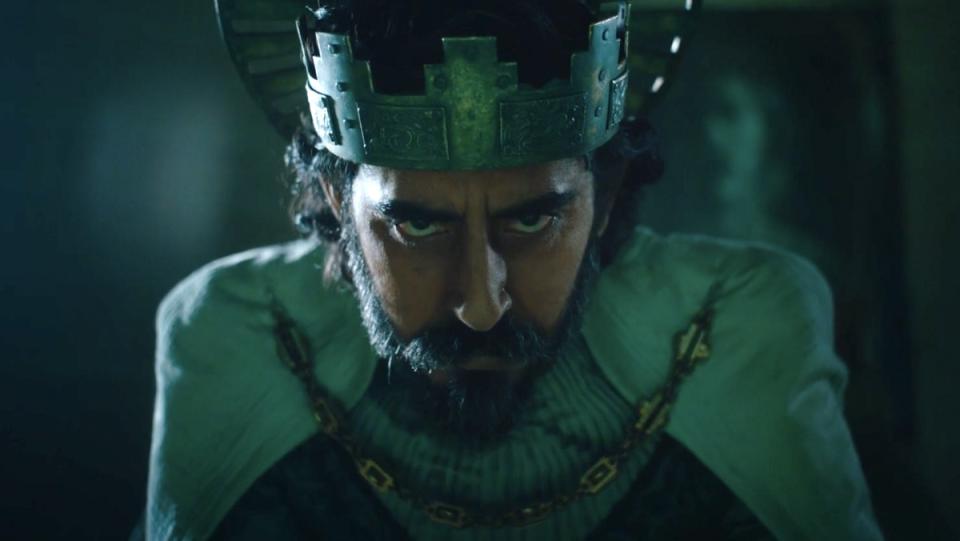 An aged, angered King Gawain (Dev Patel) wears a crown and regal robes, but his eyes betray a deep self-loathing in The Green Knight.