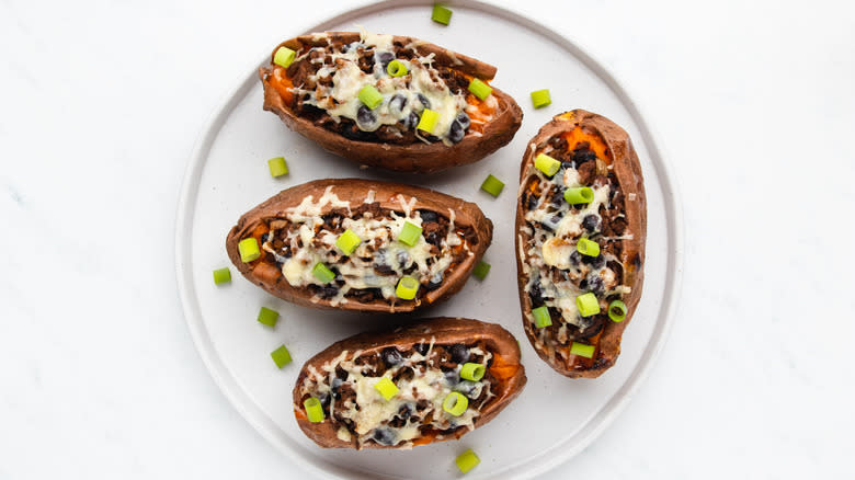 cheesy beef-stuffed sweet potatoes on plate