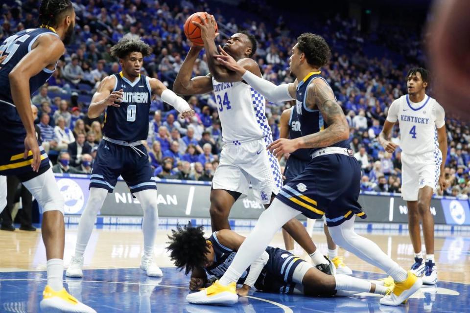 Kentucky’s Oscar Tshiebwe (34) shot over Southern’s Terrell Williams (0), P.J. Byrd, bottom, and Brion Whitley, right, during Tuesday night’s game at Rupp Arena.