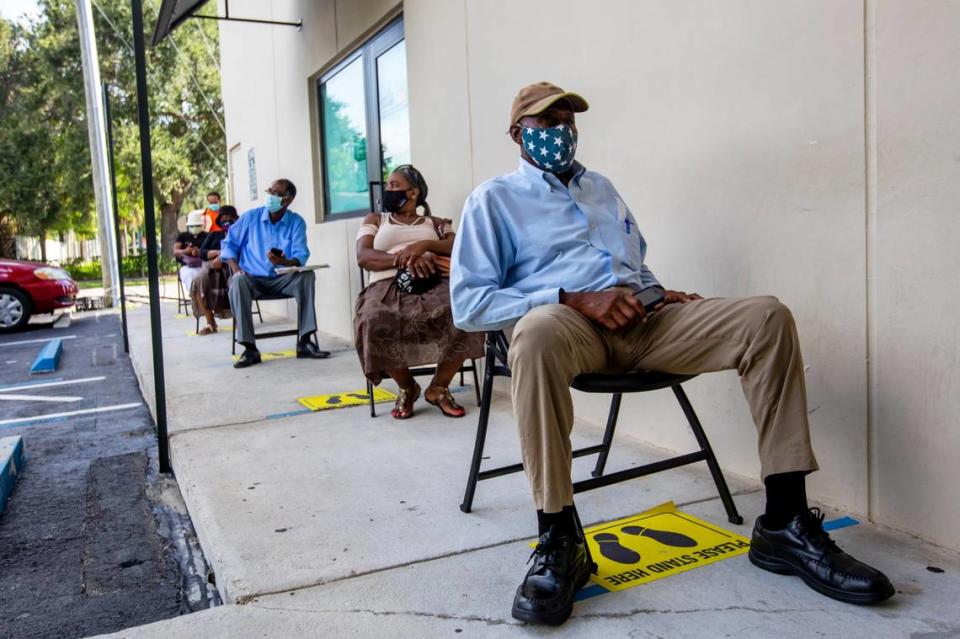 Perejona Lavenal is socially distanced as he awaits his turn for assistance with unemployment at Sant La Haitian Neighborhood Center in North Miami, Florida, on Aug. 11, 2020.