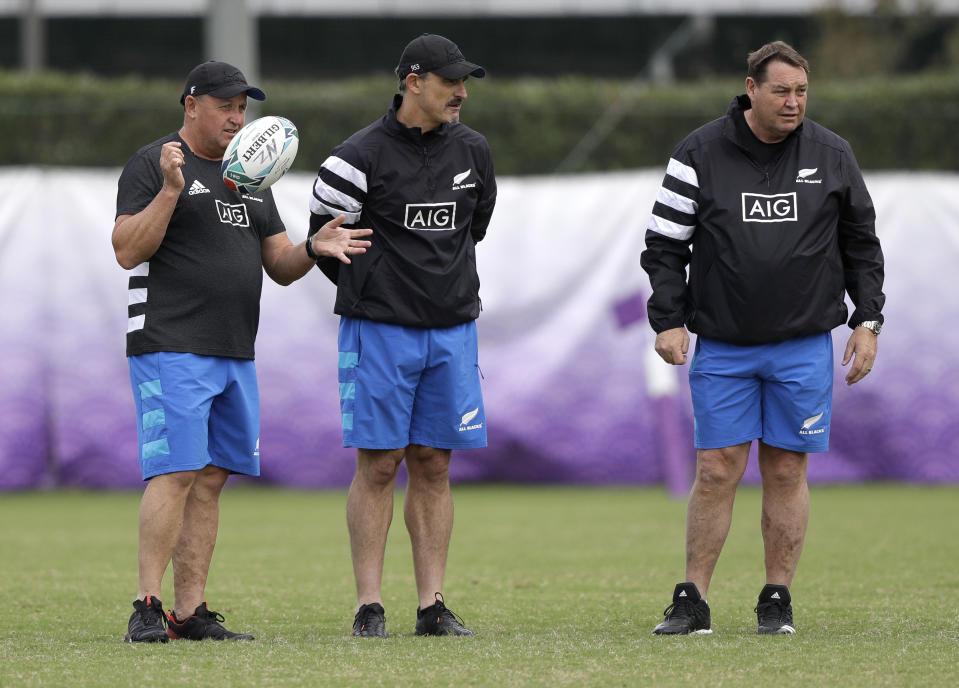 New Zealand head coach Steve Hansen, right, stands with his assistants, Ian Foster, left, and Scott McLeod during a training session in Tokyo, Japan, Tuesday, Oct. 15, 2019. The All Blacks play Ireland in a Rugby World Cup quarterfinal in Tokyo on Saturday Oct.19. (AP Photo/Mark Baker)