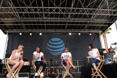 Jul 23, 2016; Los Angeles, CA, USA; American swimmer Janet Evans (right) talks to volleyball player Kerri Walsh-Jennings (left) and basketball player Tamika Catchings (second from left) and water polo player Tony Azevedo (second from right) during the Team USA Road to Rio tour announcement show at Venice Beach. Mandatory Credit: Kelvin Kuo-USA TODAY Sports