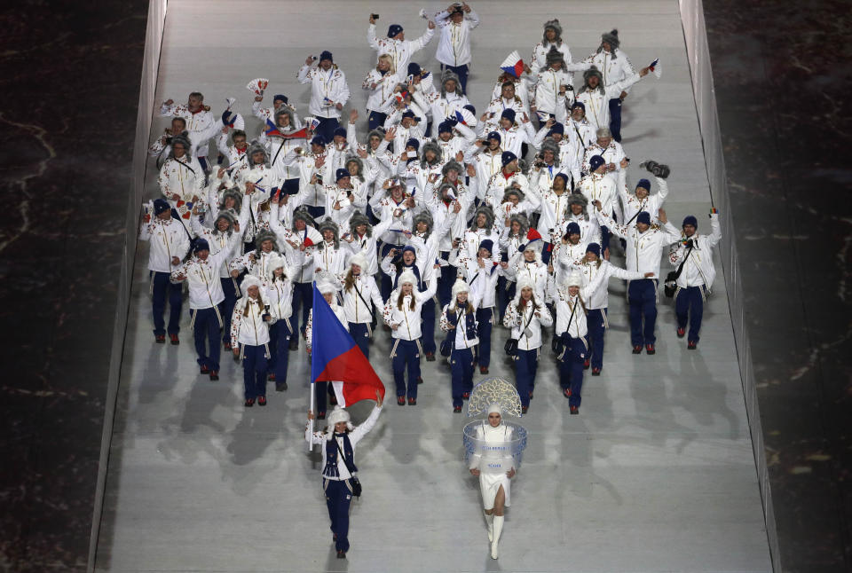 Sarka Strachova of the Czech Republic holds her national flag and enters the arena with teammates during the opening ceremony of the 2014 Winter Olympics in Sochi, Russia, Friday, Feb. 7, 2014. (AP Photo/Charlie Riedel)