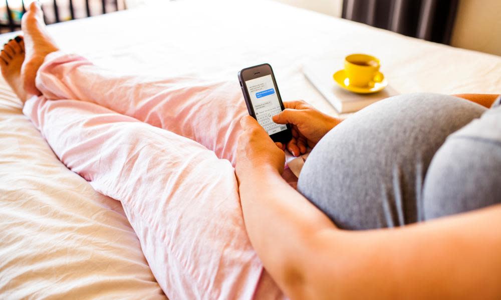 pregnant woman using phone