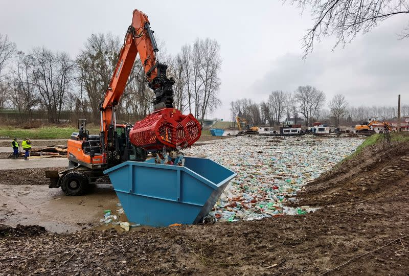 Workers collect plastic waste from Tisza river in Vasarosnameny