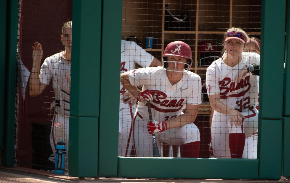 May 21, 2022; Tuscaloosa, AL, USA; Alabama first baseman Kaylee Tow (12) and Alabama outfielder Kat Grill (32) watch from the dugout as teammates bat. Stanford defeated Alabama 6-0 in the winners bracket of the NCAA Tuscaloosa Regional Saturday at Rhoads Stadium. Mandatory Credit: Gary Cosby Jr.-The Tuscaloosa News