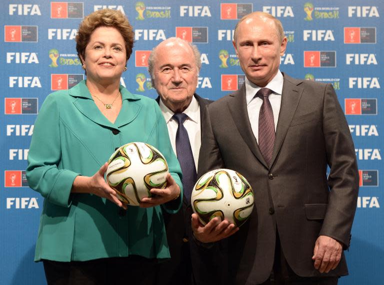 Brazil's President Dilma Rousseff, FIFA President Joseph Blatter and Russia's President Vladimir Putin pose during handing over of the 2018 FIFA World Cup to Russia on July 13, 2014 in Rio de Janeiro