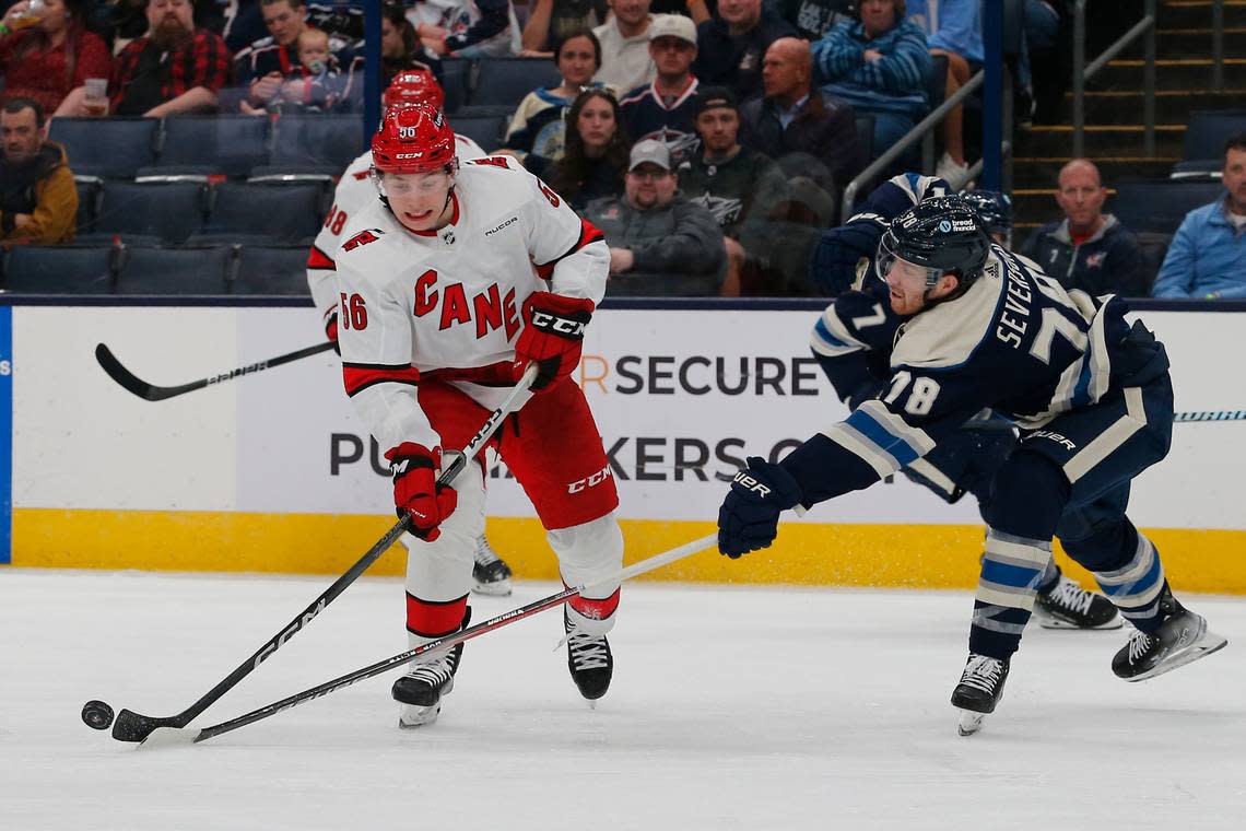 Columbus Blue Jackets defenseman Damon Severson (78) sticks the puck away from Carolina Hurricanes defenseman Scott Morrow (56) during the third period at Nationwide Arena on April 16, 2024.