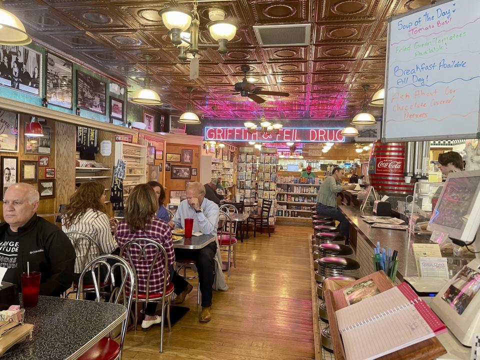 Customers dine at Griffith & Feil Drug on Thursday, March 30, 2023, in Kenova, W. Va. The pharmacy opened in 1892 with a soda fountain counter that was taken out in 1957 but reopened in 2004. (AP Photo/John Raby)