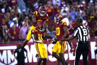 Southern California wide receiver Tahj Washington celebrates with teammates after scoring a touchdown on a pass from quarterback Caleb Williams during the first half of an NCAA college game against San Jose State, Saturday, Aug. 26, 2023, in Los Angeles. (AP Photo/Ryan Sun)