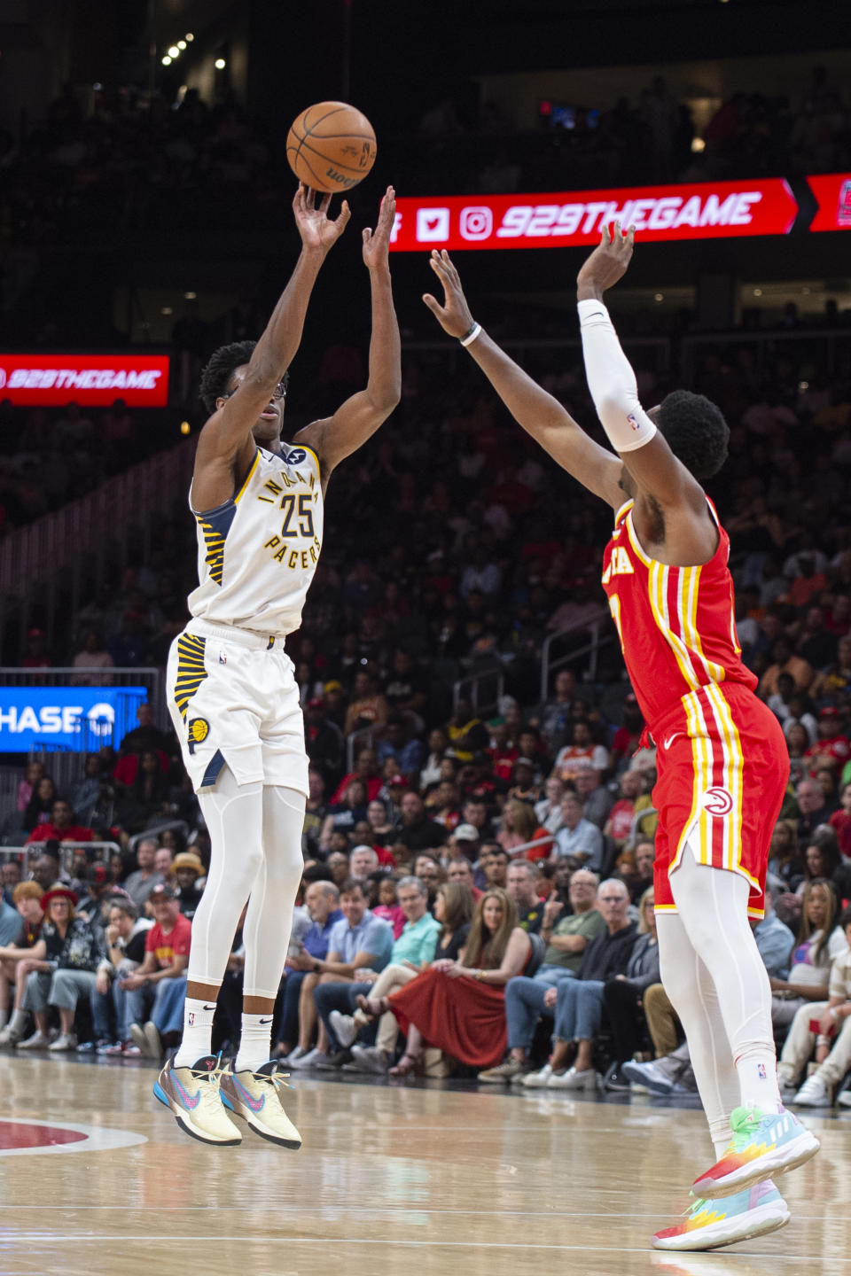 Indiana Pacers forward Jalen Smith shoots a 3-pointer over Atlanta Hawks forward Onyeka Okongwu during the second half of an NBA basketball game, Saturday, March 25, 2023, in Atlanta. (AP Photo/Hakim Wright Sr.)