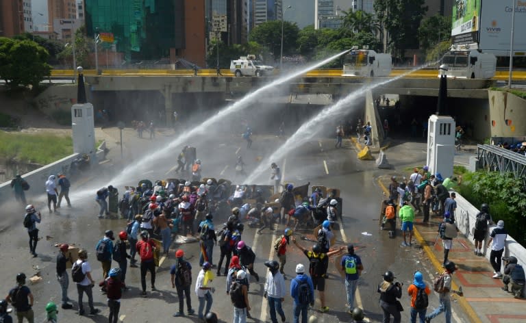 Opposition activists clash with the riot police during a march against Venezuelan President Nicolas Maduro in Caracas, on May 26, 2017