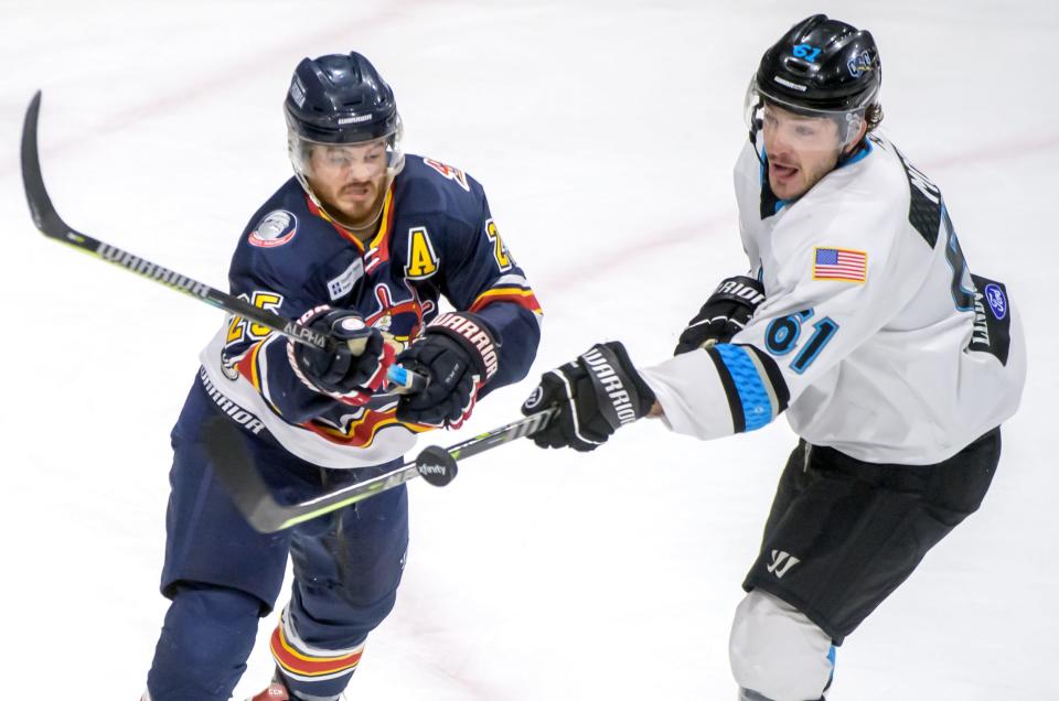 Peoria's Nick Neville, left, and Quad City's Michael Moran try to control an airborne puck in the second period of their SPHL playoff game Friday, April 22, 2022 at Carver Arena in Peoria.