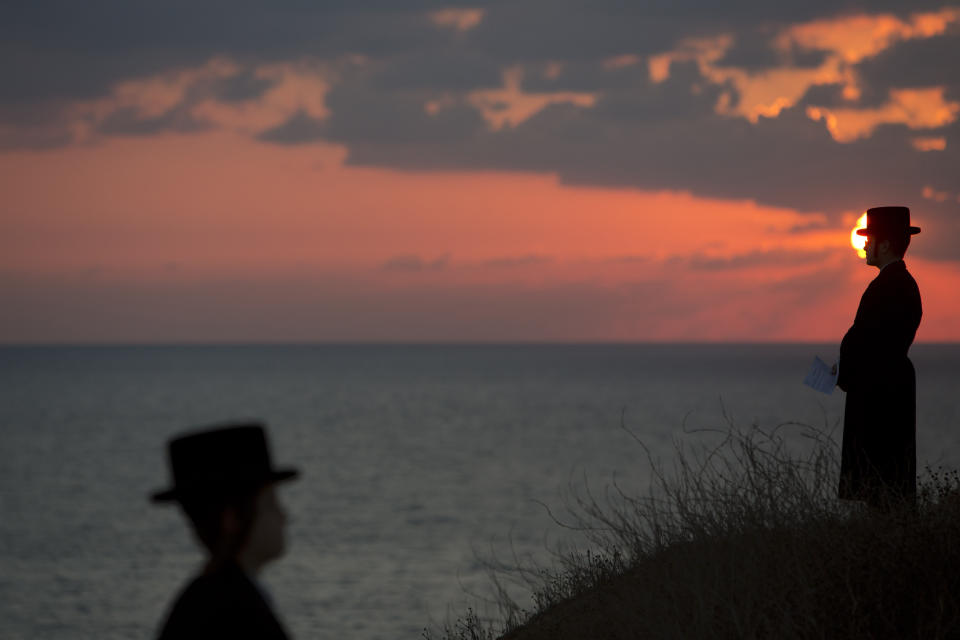<p>Ultra-Orthodox Jews of the Hassidic sect Vizhnitz gather on a hill overlooking the Mediterranean sea as they participate in a Tashlich ceremony in Herzeliya, Israel, Oct. 2, 2014. (Photo: Oded Balilty/AP) </p>