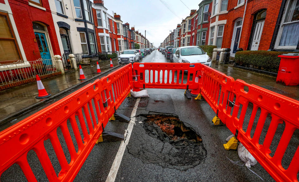 A sink hole that has appeared in Ashbourne Road in Aigburth, Liverpool, following heavy rain.