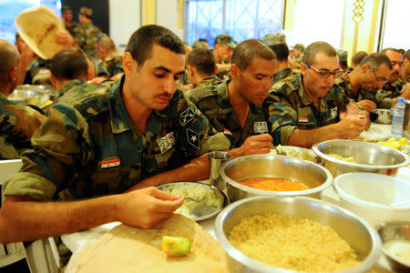 New Syrian army recruits eat their Iftar (breaking fast) meals at a military training camp in Damascus, Syria June 26, 2016. REUTERS/Omar Sanadiki/File Photo