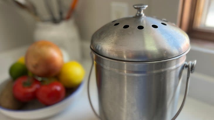 silver compost scrap bucket on counter