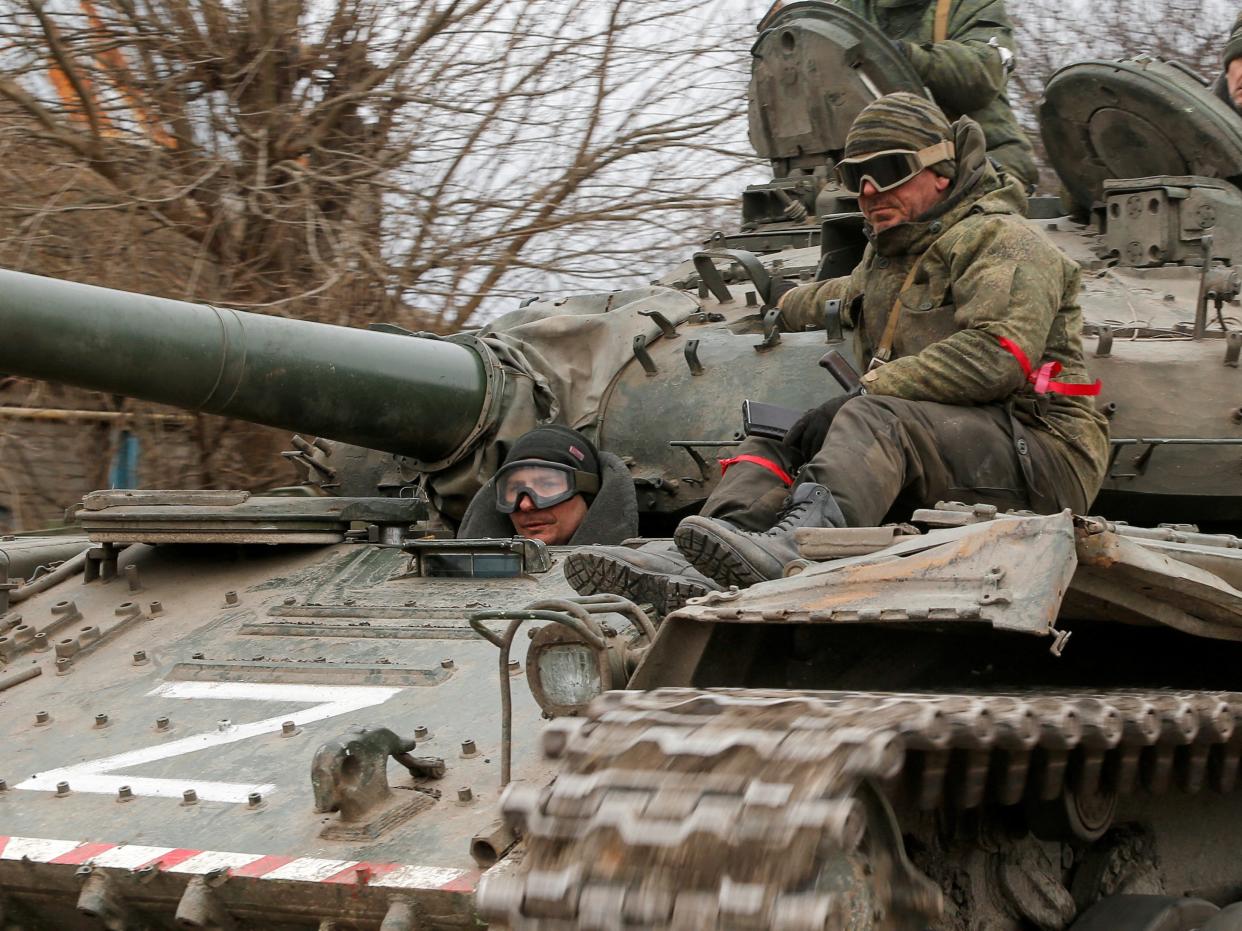 Service members of pro-Russian troops in uniforms without insignia are seen atop of a tank with the letter "Z" painted on its sides in the separatist-controlled settlement of Buhas (Bugas), as Russia's invasion of Ukraine continues, in the Donetsk region, Ukraine March 1, 2022.