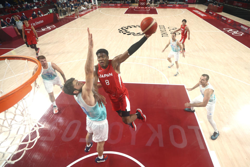 Japan' Rui Hachimura (8) drives to the basket against Slovenia's Mike Tobey (10) during a men's basketball preliminary round game at the 2020 Summer Olympics, Sunday, July 25, 2021, in Saitama, Japan. (Gregory Shamus/Pool Photo via AP)