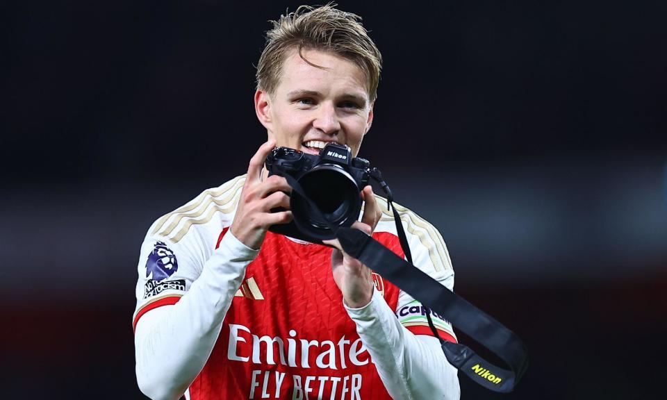 <span>Martin Ødegaard takes a picture with the club photographer’s camera, which irked Sky pundit Jamie Carragher. </span><span>Photograph: Michael Zemanek/Shutterstock</span>