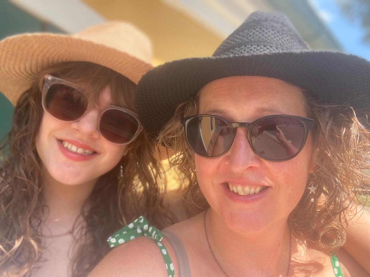 Catherine and Carla Santamaria wearing sunglasses and smiling at the camera 