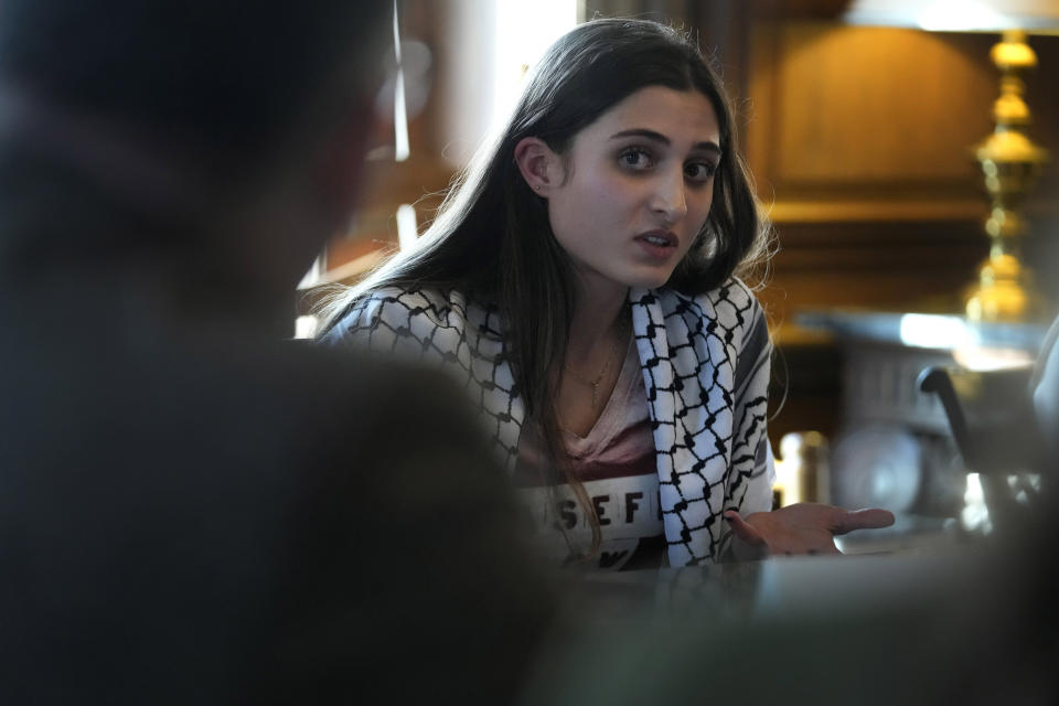 Dartmouth College student Yasmine Abouali, of Palestinian Tunisian heritage, speaks with U.S. Education Secretary Miguel Cardona, left, as they participate in a roundtable discussion with students from Dartmouth College, Wednesday, Jan. 10, 2024, on the school's campus in Hanover, N.H. Fallout from the Israel-Hamas war has roiled campuses across the U.S. and reignited a debate over free speech. (AP Photo/Steven Senne)