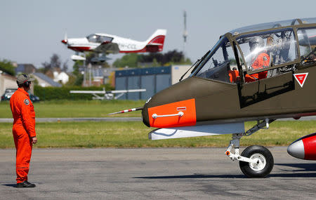 A technician inspects an OV-10 Bronco aircraft before taking off at Flanders international airport, ahead of the world's first Short Take Off & Landing competition on sand, in Wevelgem Belgium May 8, 2018. REUTERS/Francois Lenoir