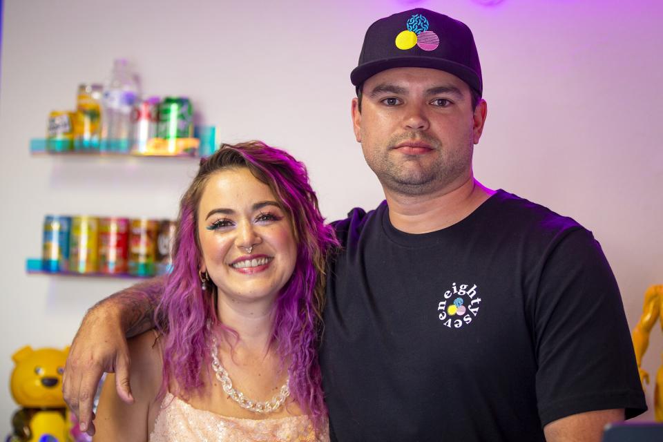 Eighty Seven owners, Mallory Ruiz and John Moody, pose for a photo at the grand opening of their new shop on Grand Avenue in Phoenix on Nov. 20, 2021.