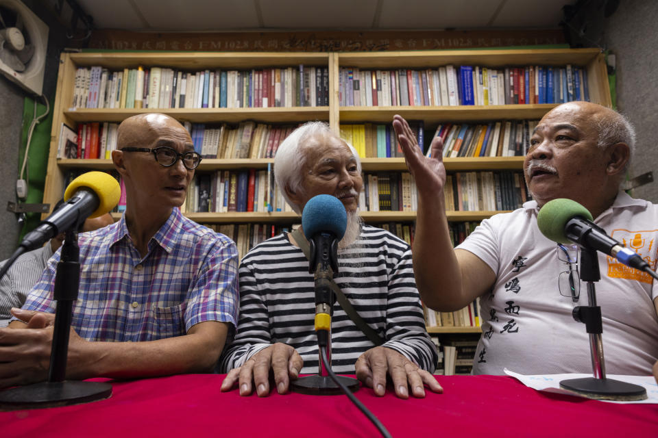 "The Bull" Tsang Kin-shing, right, founder of Hong Kong's pro-democracy Citizens' Radio station, along with guests, hold their last broadcast in Hong Kong, Friday, June 30, 2023. (AP Photo/Louise Delmotte)