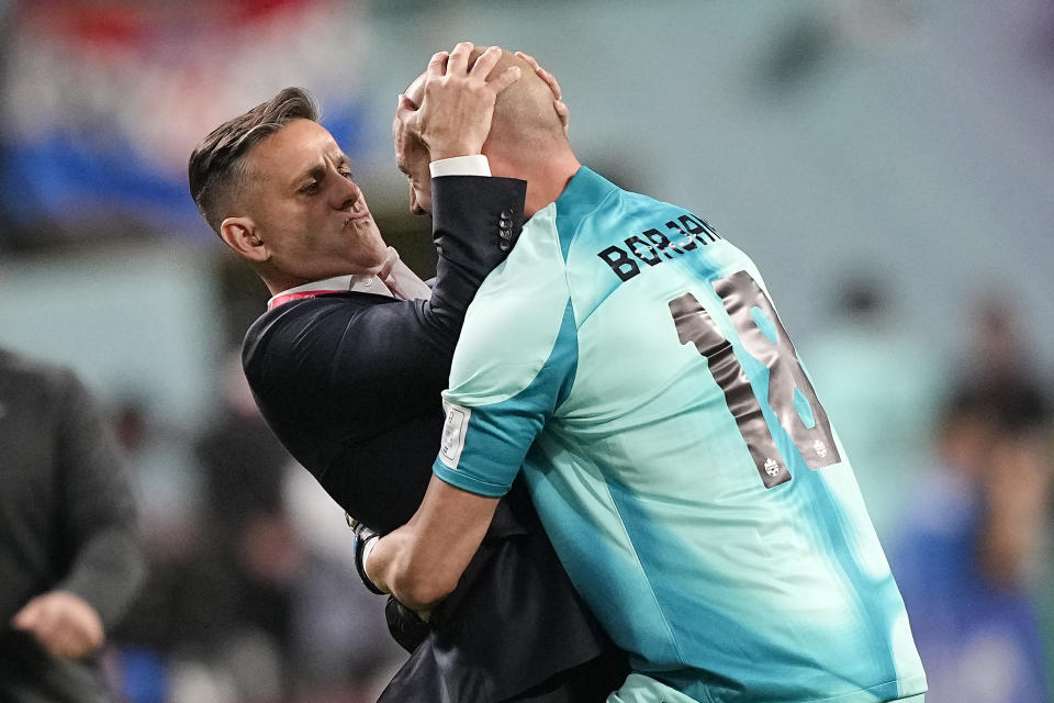 Canada's goalkeeper Milan Borjan embraces Canada's head coach John Herdman, left, after they scored the opening goal during the World Cup group F soccer match between Croatia and Canada, at the Khalifa International Stadium in Doha, Qatar, Sunday, Nov. 27, 2022. (AP Photo/Martin Meissner)