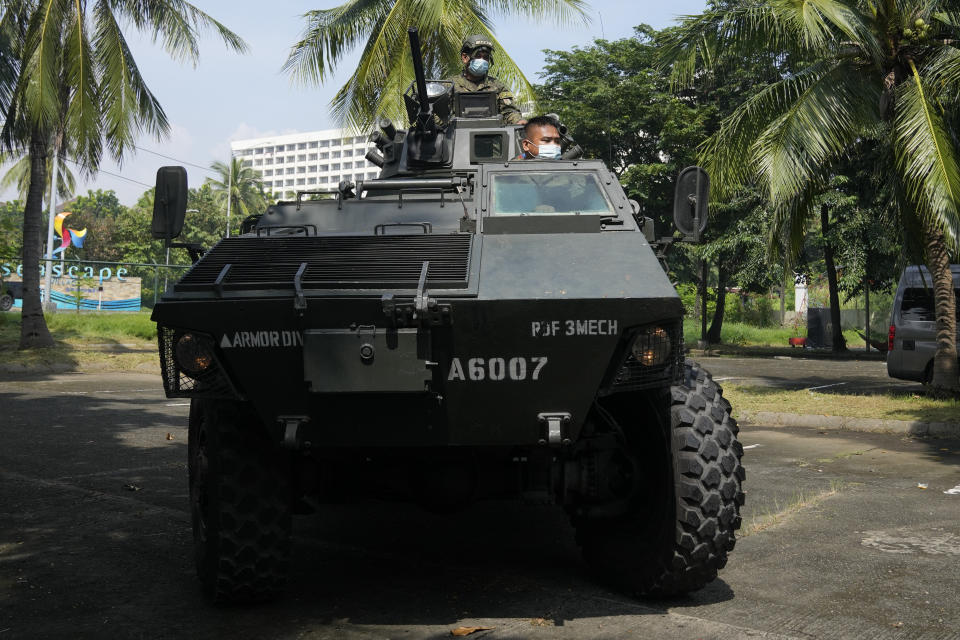 A military truck maneuvers as they secure an area where politicians will file their certificate of candidacy before the Commission on Elections at the Sofitel Harbor Garden Tent on Friday, Oct. 1, 2021 in Manila, Philippines. Friday marks the start of a weeklong registration period for candidates seeking to lead a Southeast Asian nation that has been hit hard by the pandemic and deep political conflicts. (AP Photo/Aaron Favila)