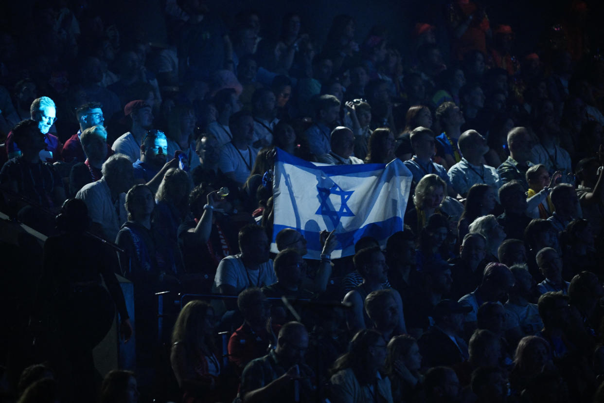 Fans hold up an Israeli flag as Eden Golan representing Israel with the song 