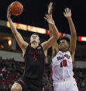 San Diego State's Yanni Wetzell shoots next to Fresno State's Orlando Robinson during the first half of an NCAA college basketball game in Fresno, Calif., Tuesday Jan. 14, 2020. (AP Photo/Gary Kazanjian)