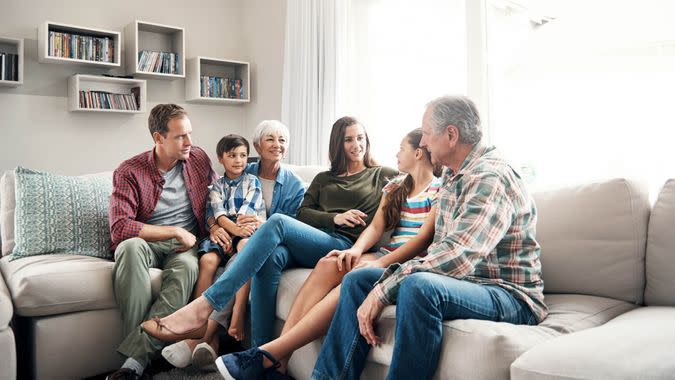 three-generational family sitting together on a sofa at home.